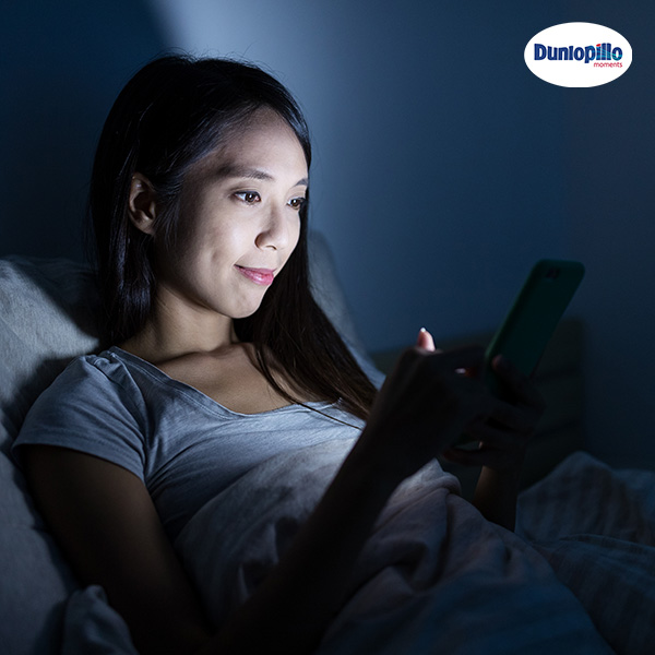 Women Looking At Phone In Dark Before Bed